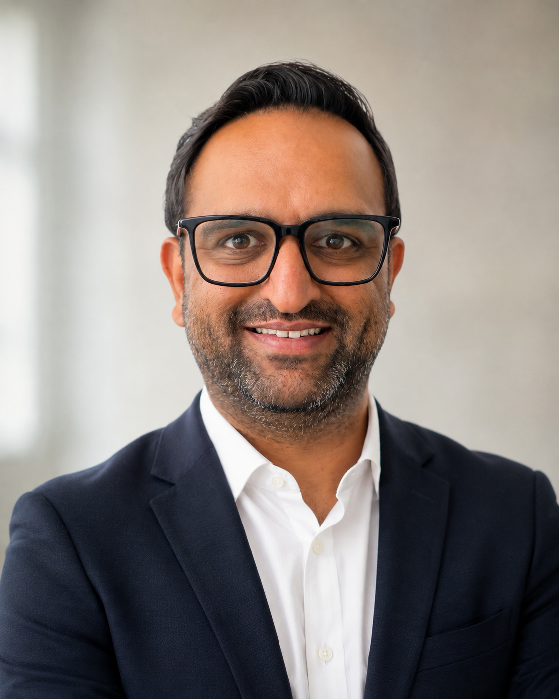 Vikram Dhani, Certified Dementia Practitioner and founder of Saharo Dementia Navigator, seated in a warm, plant-filled room during an online family session