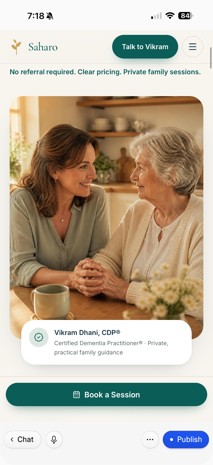 An adult daughter and her mother sitting together at a sunlit kitchen table, talking over notes and a calendar while planning care at home